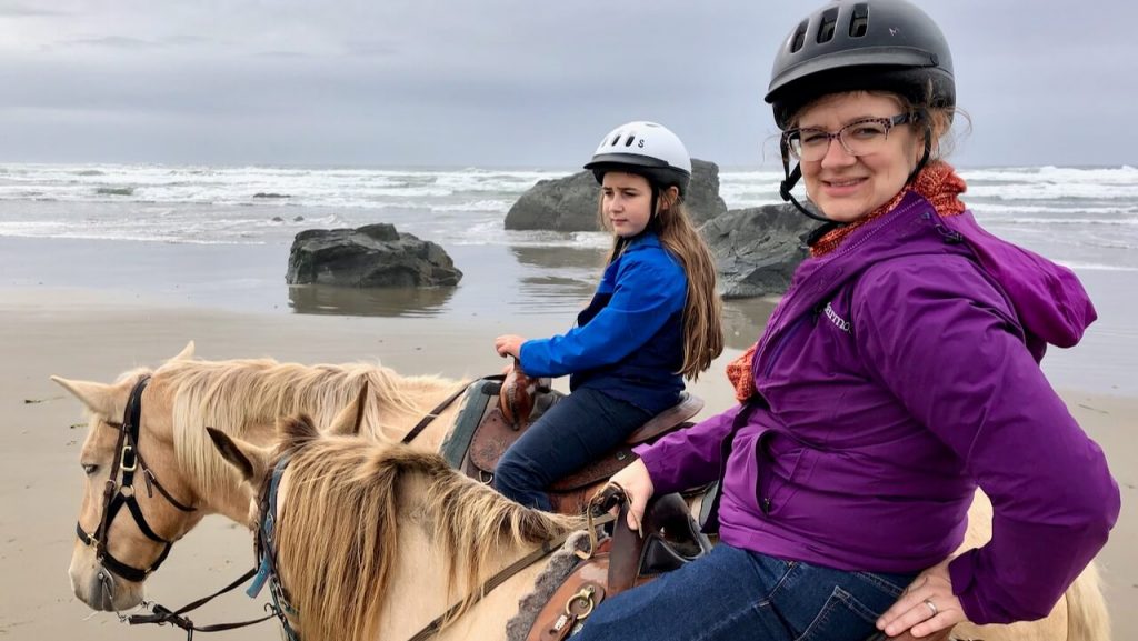 Amputee mama rides horses with her kids and husband along the beach in Bandon, Oregon.
